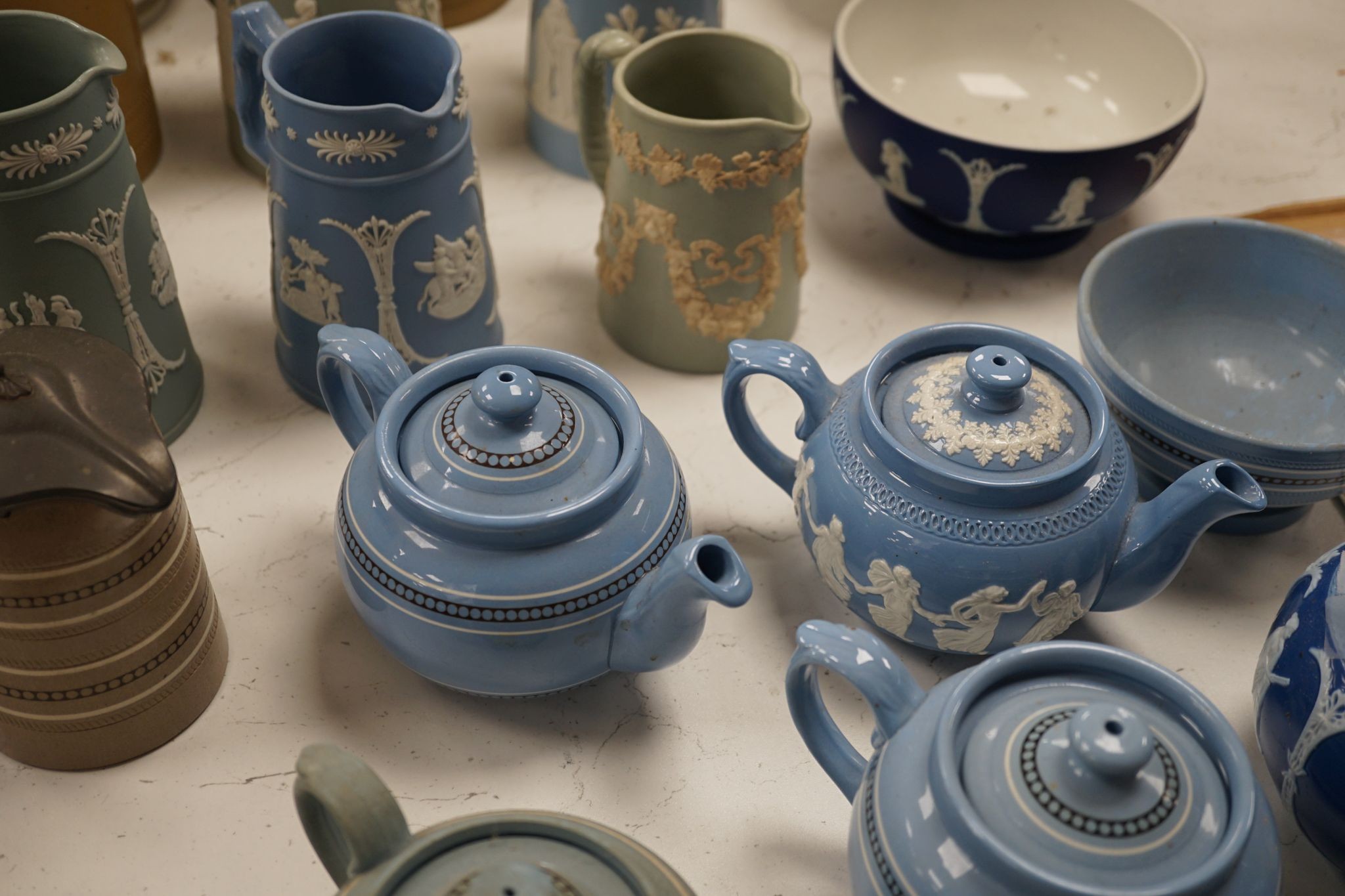 A collection of Dudson stoneware, including jugs, teapots, cream jugs etc, many decorated in low relief